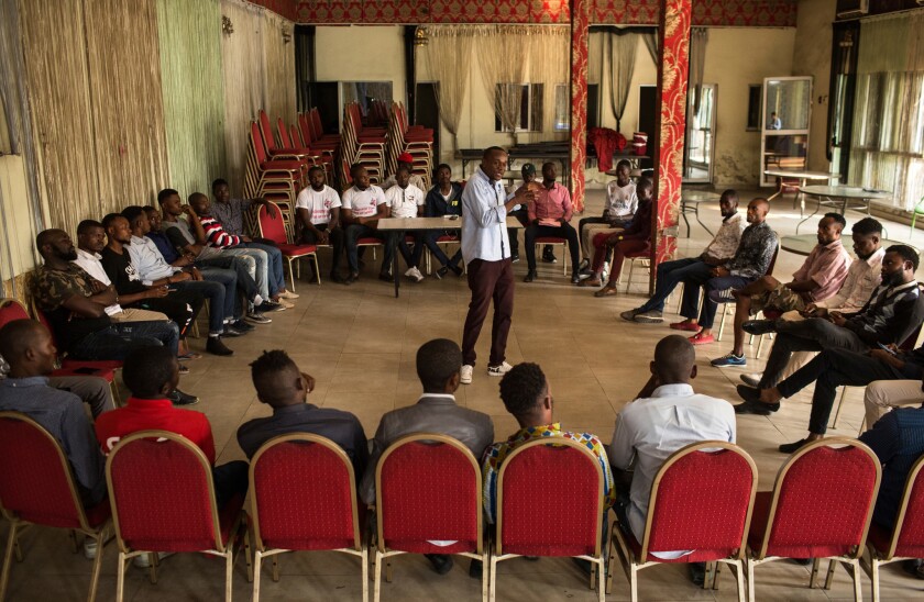Alain Mulumba Kabeya, 28, interim coordinator for the Kinshasa cell of Filimbi, a pro-democracy group, leads a secret meeting of the group in Kinshasa, Congo, on Aug. 14, 2018. Filimbi members had just spent the day in court, supporting their imprisoned colleagues.
