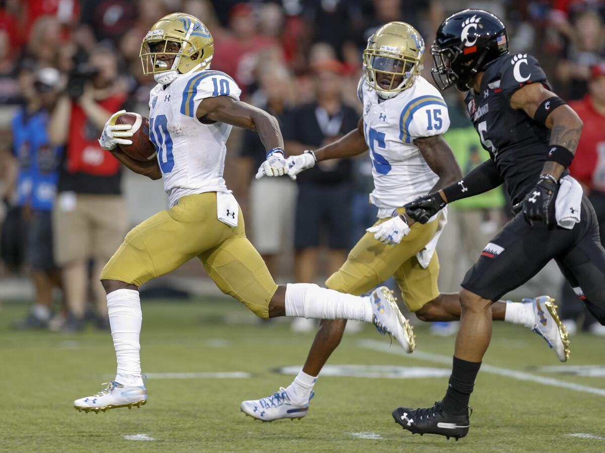 UCLA running back Demetric Felton carries the ball for a touchdown during the second quarter of the Bruins' loss to Cincinnati on Thursday.