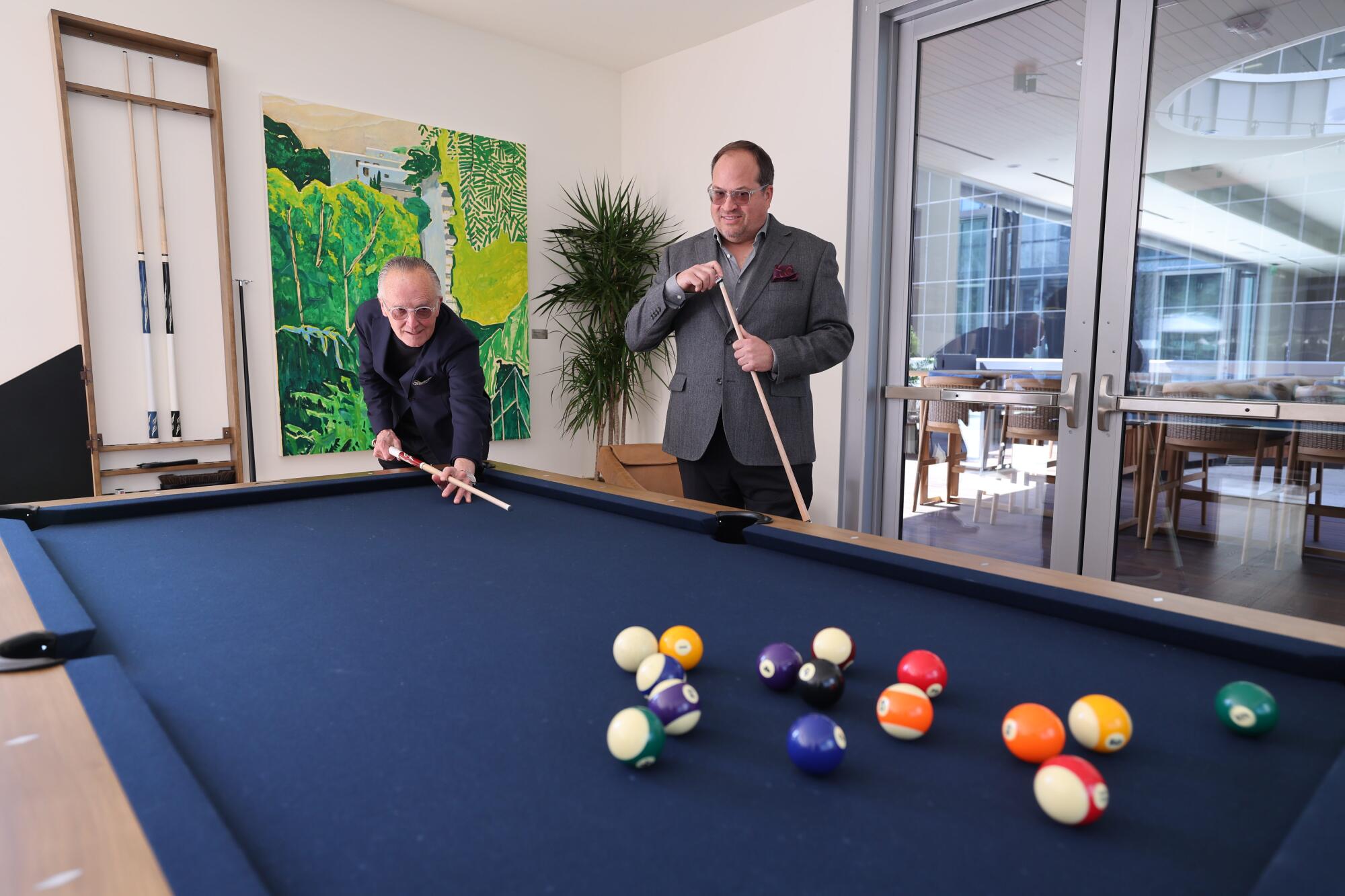 Architect Scott Johnson, left, and developer Stuart Morkun of Mitsui Fudosan America shoot pool.