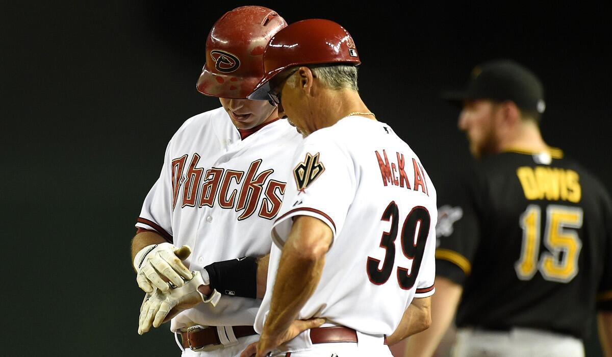 Diamondbacks slugger Paul Goldschmidt shows first base coach Dave McKay where a pitch struck his left hand on Friday night in Pittsburgh.