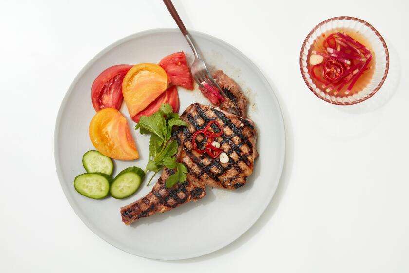LOS ANGELES- May 15, 2019; Grilled Pork Chops with Tomatoes styled by Genevieve Ko and prop styled by Kate Parisian at PropLink Studio in downtown Los Angeles. Pascal Shirley / For The Times