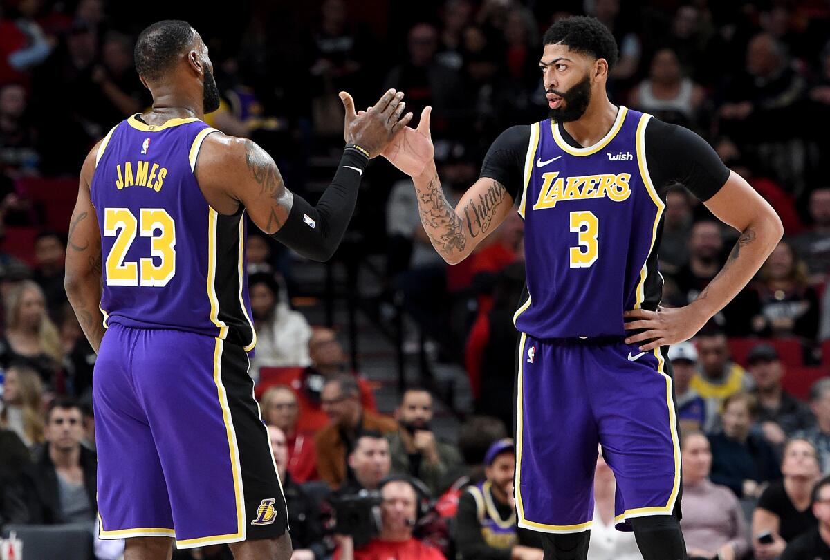 Anthony Davis and LeBron James high-five during the second half against the Trail Blazers on Dec. 6, 2019.