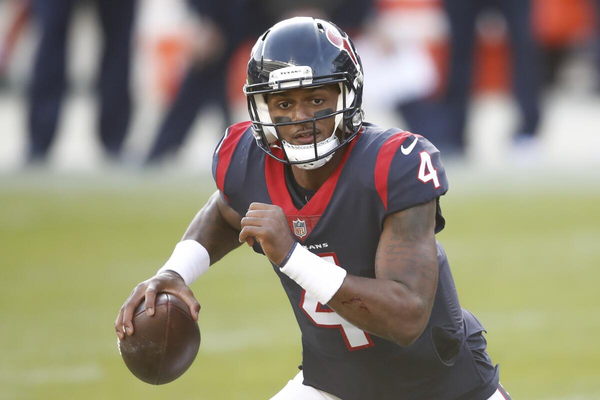 Houston Texans quarterback Deshaun Watson runs with the ball during a game.