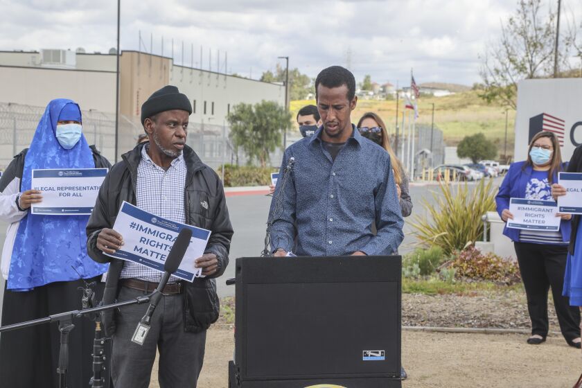 SAN DIEGO, CA - APRIL 27: Immigrant Mustafe Hassan (right) through translator Hussein Nur (left) speaks about a plan to provide legal representation for immigrants facing removal proceedings while standing in front of the Otay Mesa Detention Center on Tuesday, April 27, 2021 in San Diego, CA. (Eduardo Contreras / The San Diego Union-Tribune)