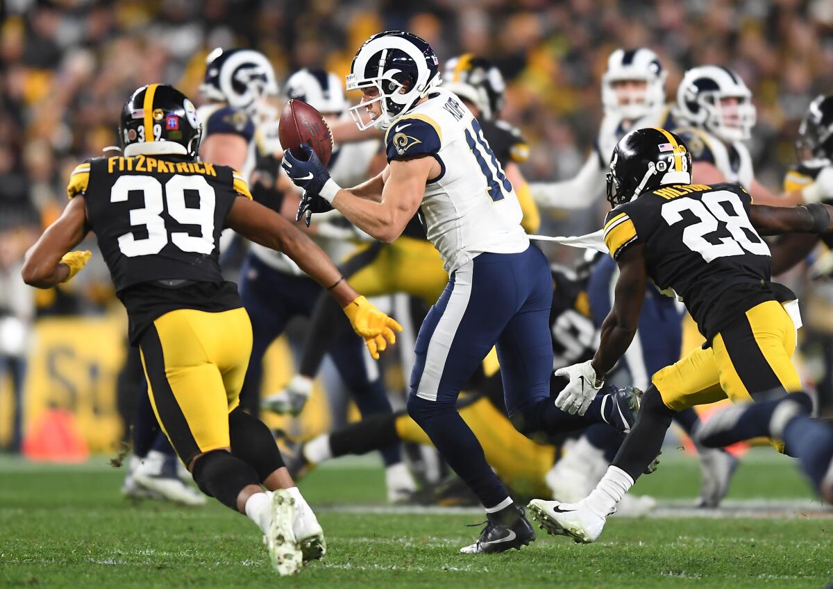 Rams receiver Cooper Kupp drops a pass as Steelers safety Minkah Fitzpratrick (39) and cornerback Mike Hilton pursue. Kupp went 