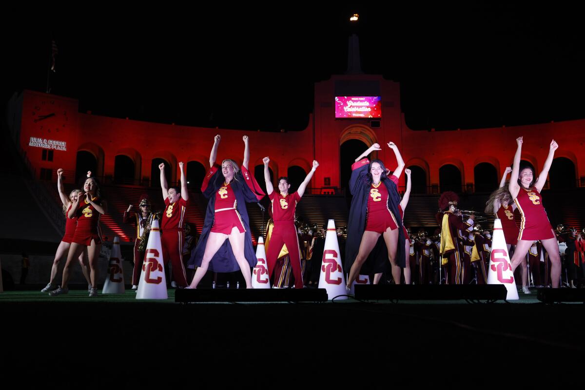 Members of the USC cheerleading squad perform at the "Troy Family graduation party," at the Coliseum on May 9.