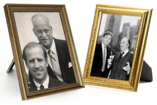 two framed photos. One of Joe Biden Jr. and Joe Biden Sr., the other of Donald Trump and Fred Trump