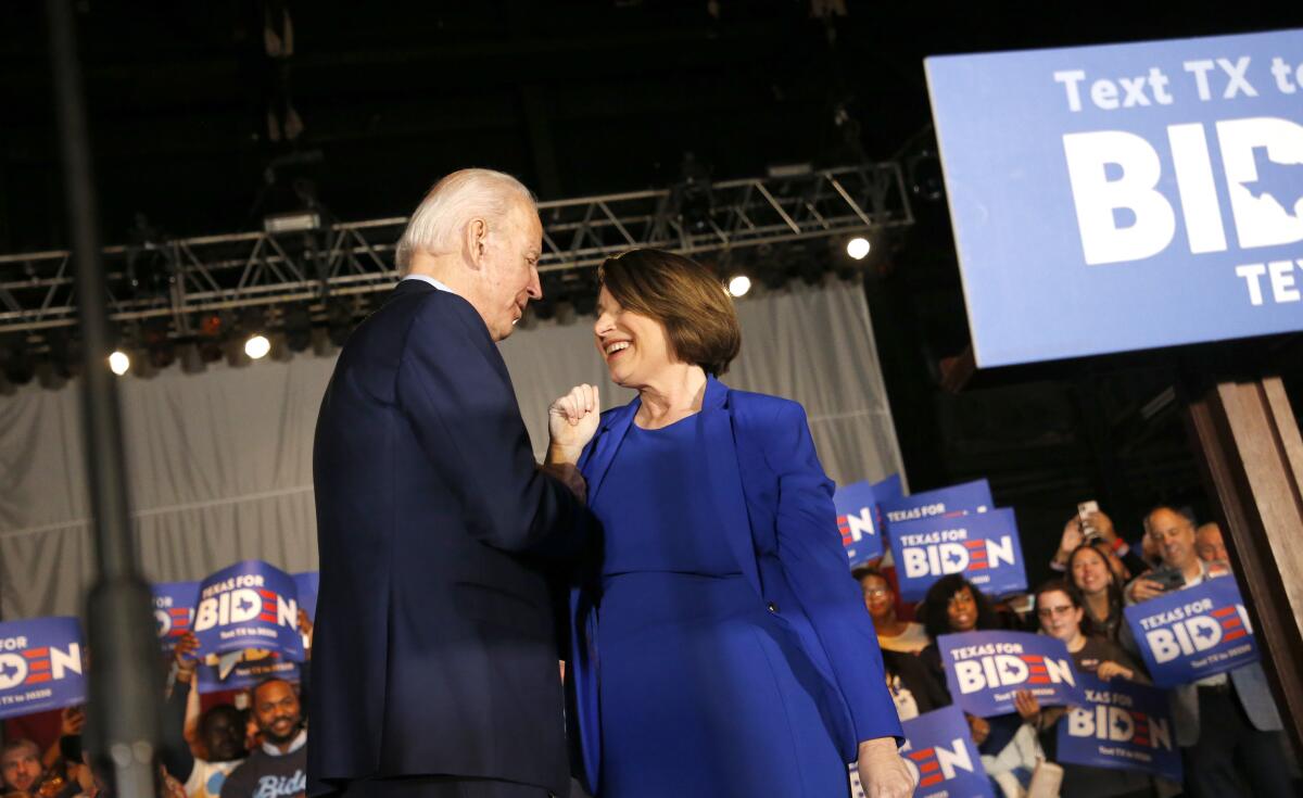 Democratic presidential candidate former Vice President Joe Biden is joined on stage by Sen. Amy Klobuchar (D-MN) during a campaign event Monday in Dallas, Texas.