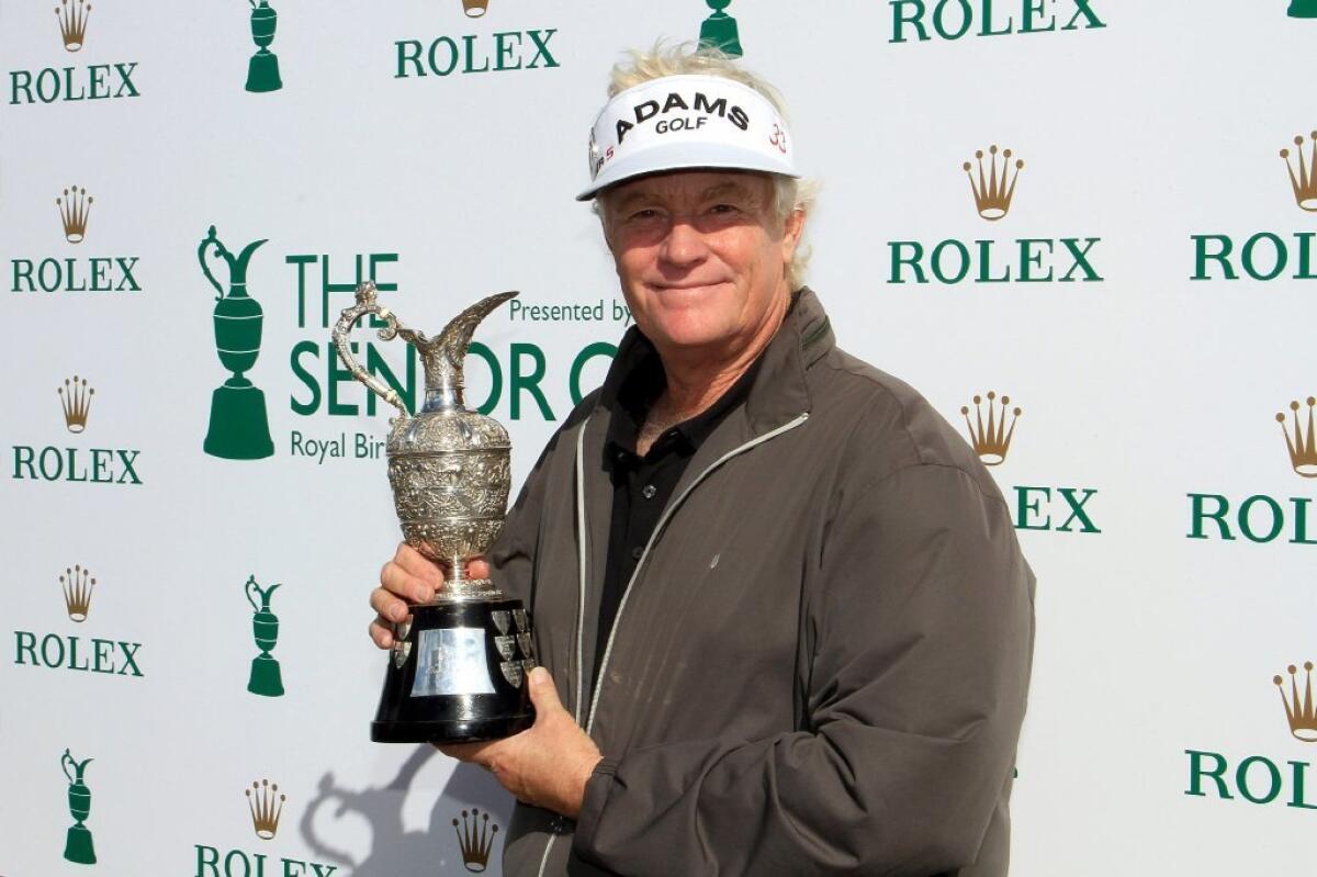 Mark Wiebe poses with the trophy he received for winning the Senior British Open.