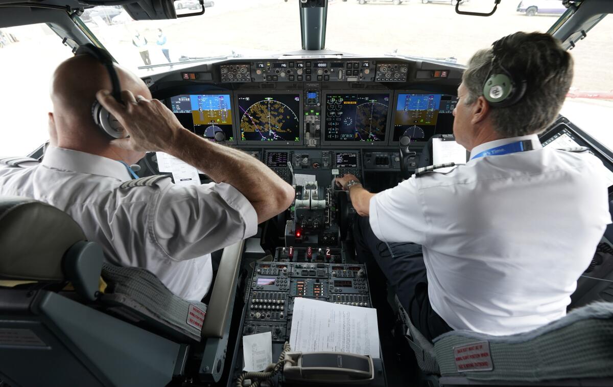 Pilots in the cockpit of a Boeing 737 Max jet.