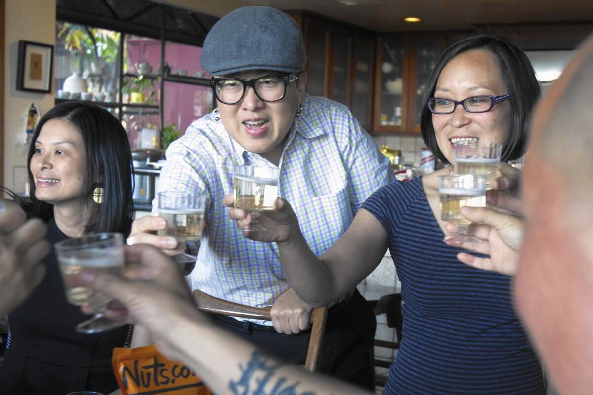 Geneva Tien, from left, Alice Y. Hom and Leslie Ito make a toast with Steve Wong during their fourth annual dumpling party in South Pasadena. Ito wanted to establish a giving circle where members of the Asian Americans/Pacific Islanders in Philanthropy gathered to talk about why they give and who they choose.