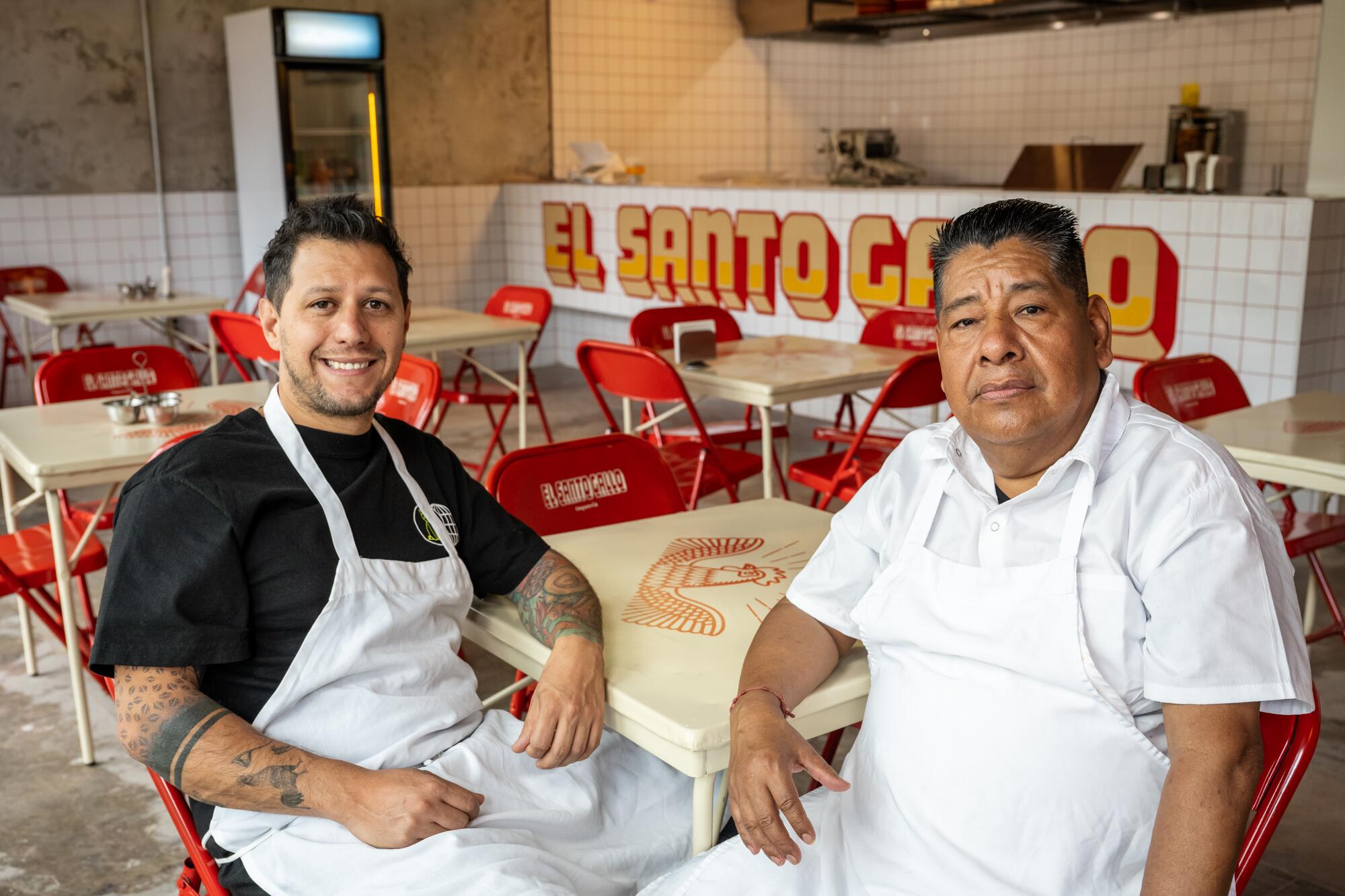 Chef Santiago Gomez sits at a table with taquero Ramon Martinez.