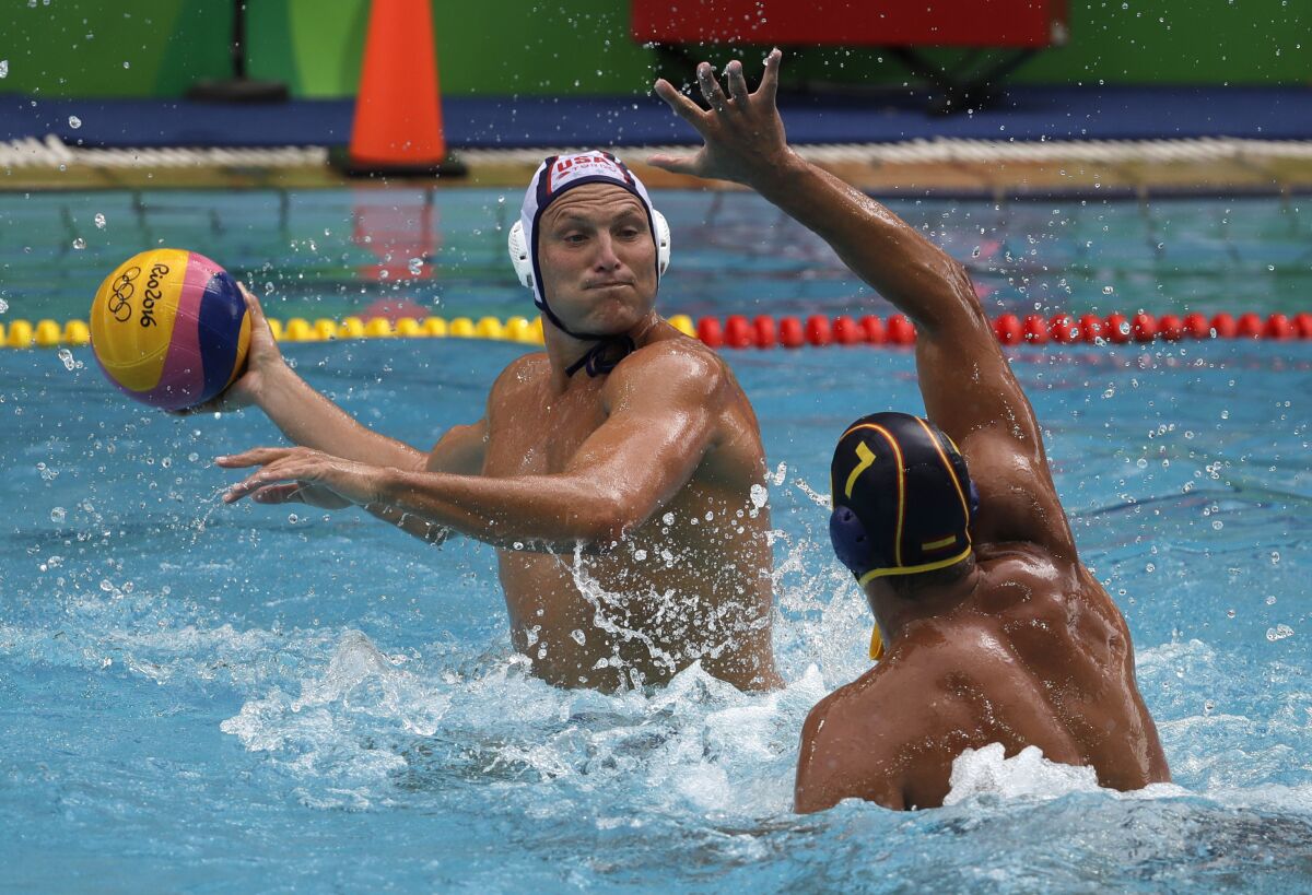 FILE - In this Aug. 8, 2016, file photo, United States' Jesse Smith, left, shoots as Spain's Balasz Sziranyi Somogyi defends during their men's water polo preliminary round match at the Summer Olympics in Rio de Janeiro, Brazil. Smith is heading to his record-tying fifth Olympics after he was selected Friday, July 2, 2021, for the U.S. men's water polo team for the Tokyo Games. (AP Photo/Eduardo Verdugo, File)