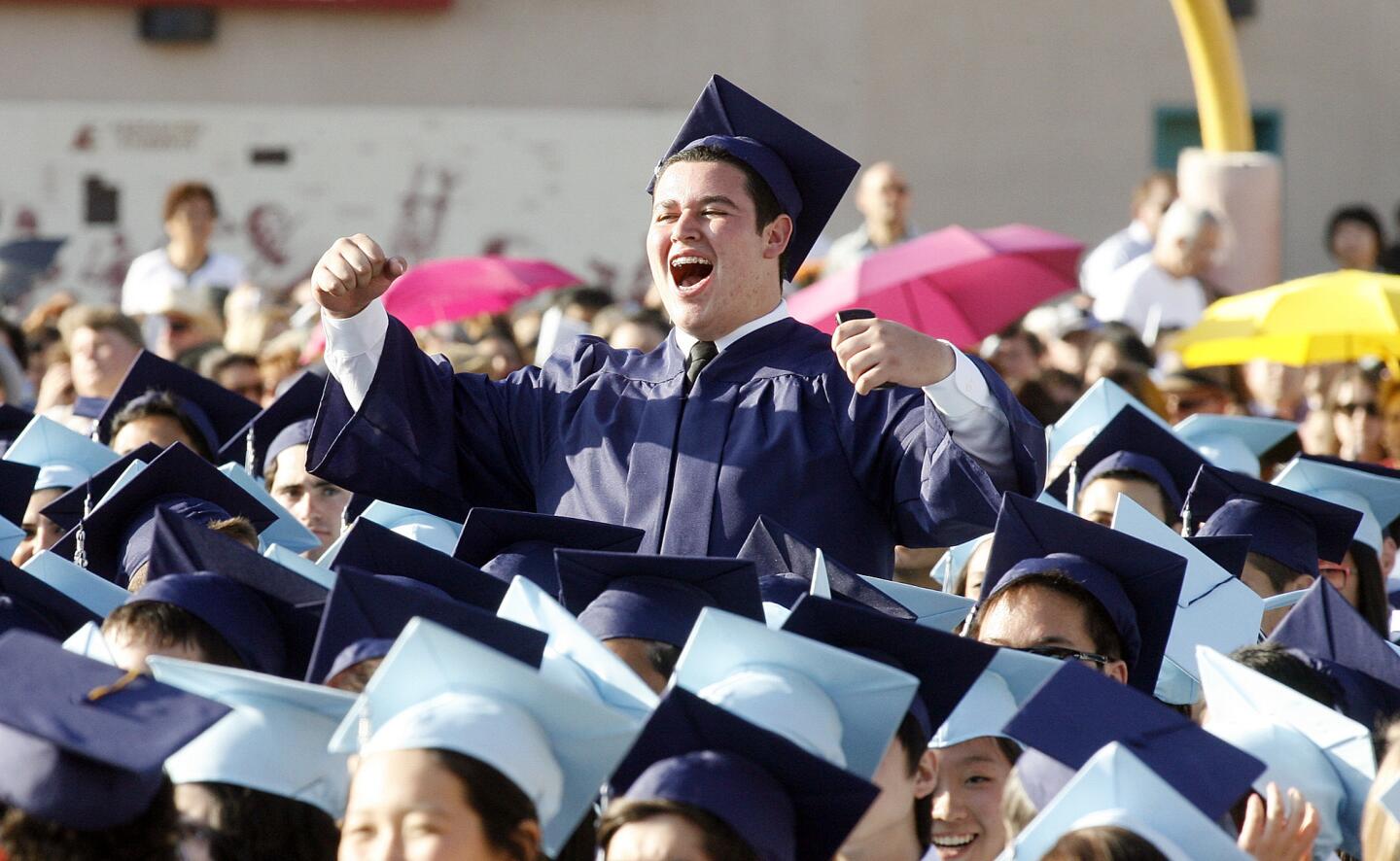 Crescenta Valley High School graduate Masis Ohanesyan cheers as parents are acknowledged at the school's commencement ceremony at Glendale Community College.