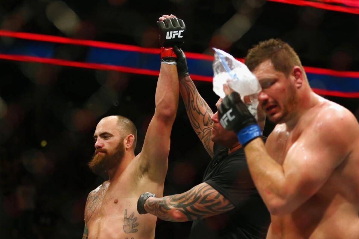 Travis Browne, left, defeated Matt Mitrione via third-round technical knockout on Sunday night in Boston.