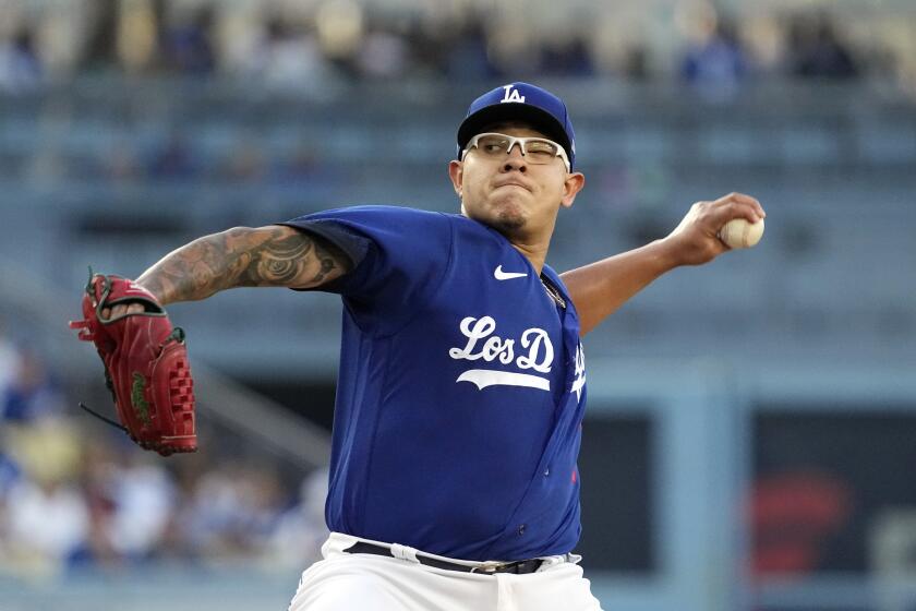 Dodgers starting pitcher Julio Urias leans back and throws to the plate against the Pirates 