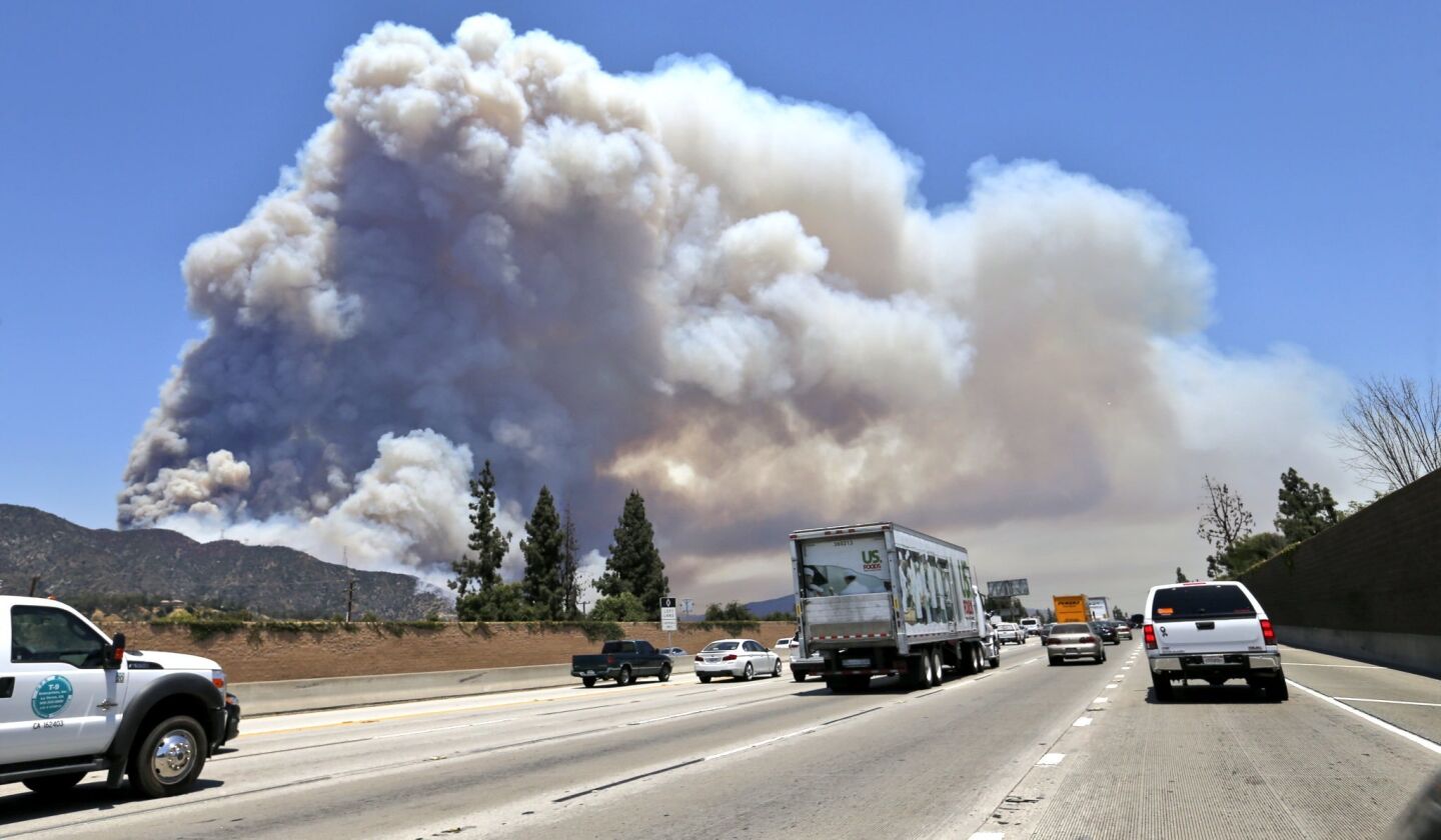 Smoke is visible from the 210 Freeway as two brush fires burn in Duarte and Azusa.