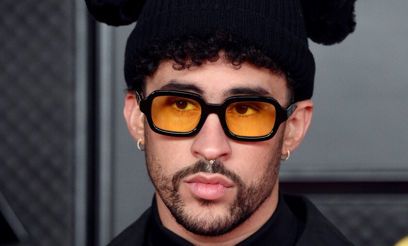 Bad Bunny in orange-tinted glasses and a black beanie