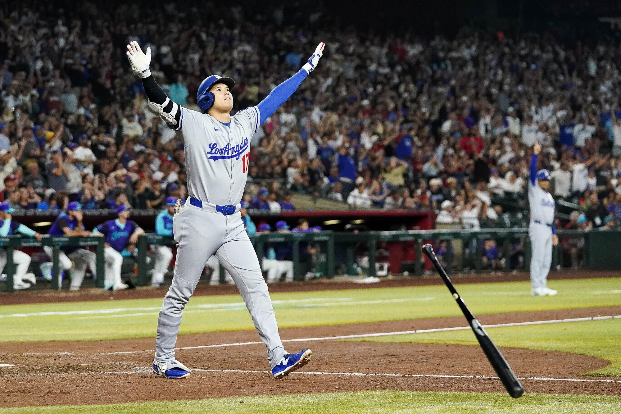 Dodgers star Shohei Ohtani celebrates immediately after hitting a three-run home run.