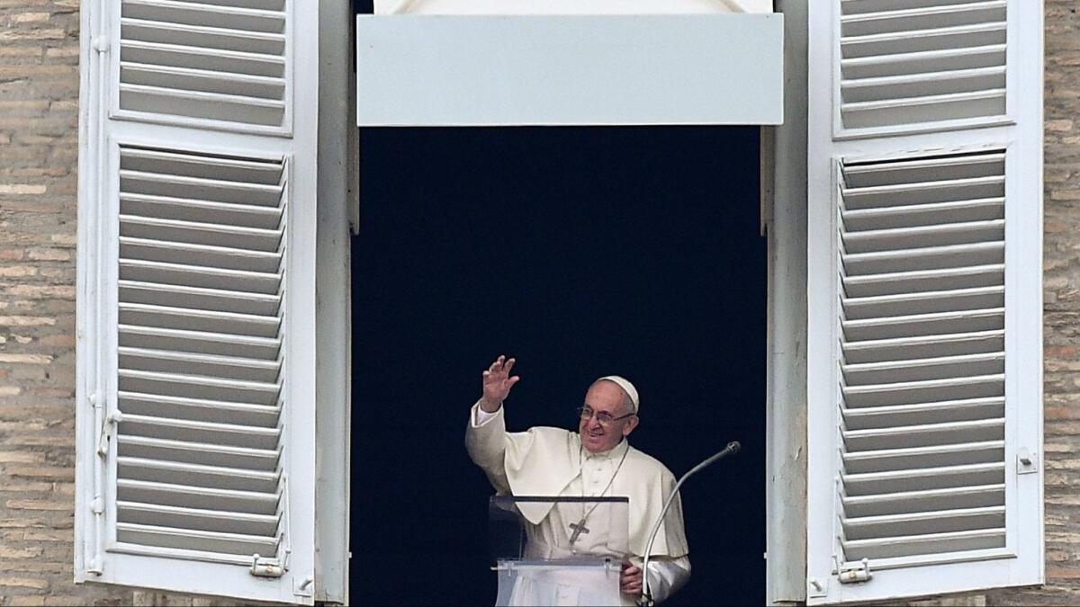 Pope Francis waves as he arrive to deliver his message to pilgrims gathered in St. Peter's Square, during his Angelus Sunday prayer at the Vatican on Jan. 14, 2018.