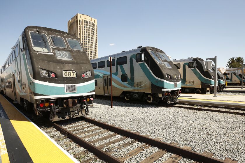 LOS ANGELES, CA - MARCH 26, 2020 Metrolink trains idle at Union Station on Thursday March 26, 2020 as ridership plunges amid the ongoing coronavirus outbreak. Metrolink has significantly scaled back its schedule, effectively reducing its service by 30%, officials said. The new schedule, effective Thursday until further notice, was crafted "to ensure plenty of service during peak times for those who need it, and to ensure we maintain as many connections as possible," according to Stephanie Wiggins, chief executive of the commuter rail network. (Al Seib / Los Angeles Times)