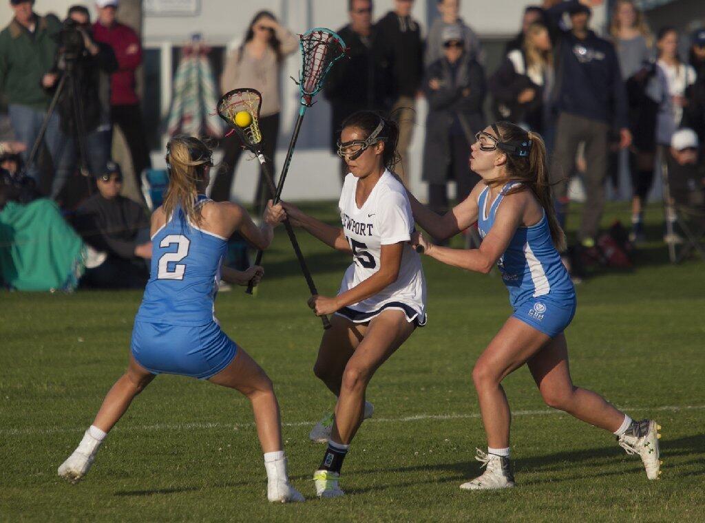 Newport Harbor High's Lauren Tran splits two Corona del Mar defenders during the Battle of the Bay.