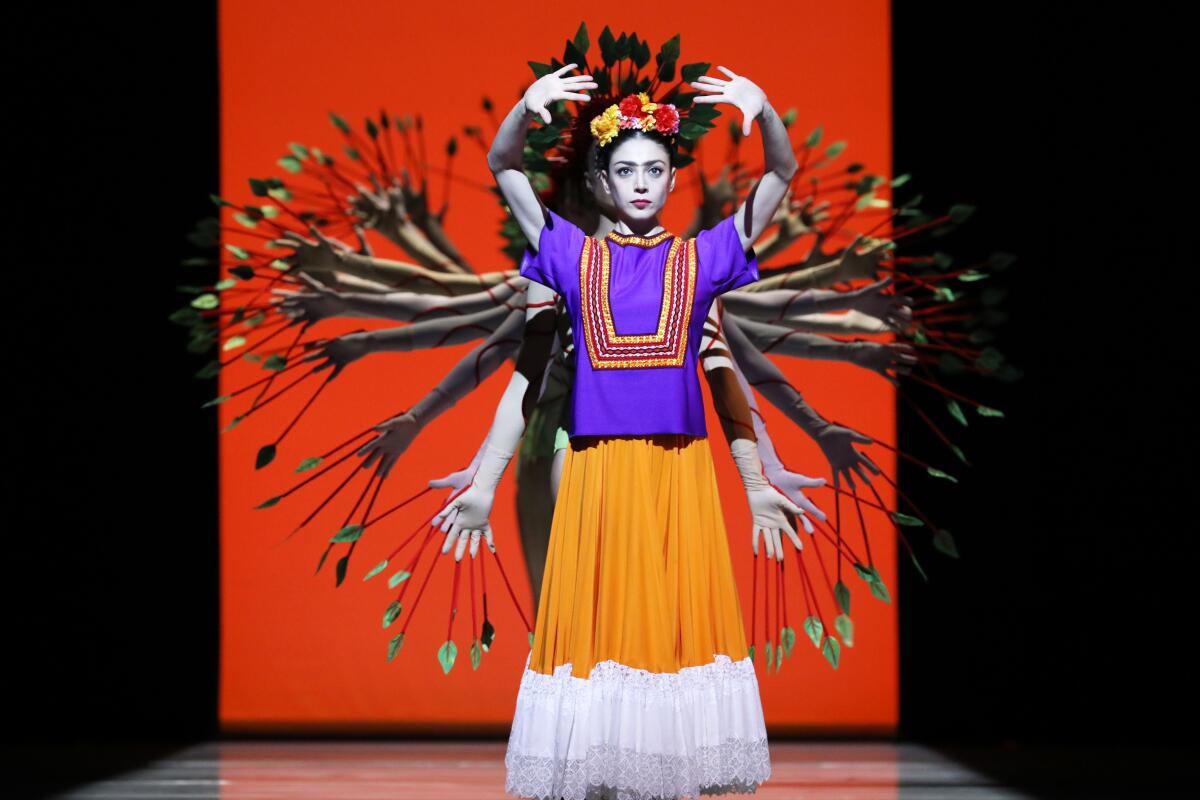 A dancer performs dressed as Mexican artist Frida Kahlo