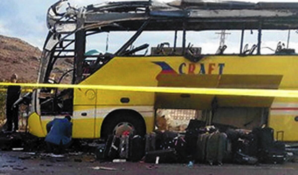 A burned-out tourist bus sits in the Egyptian Sinai resort town of Taba after a bomb went off, killing at least four people.