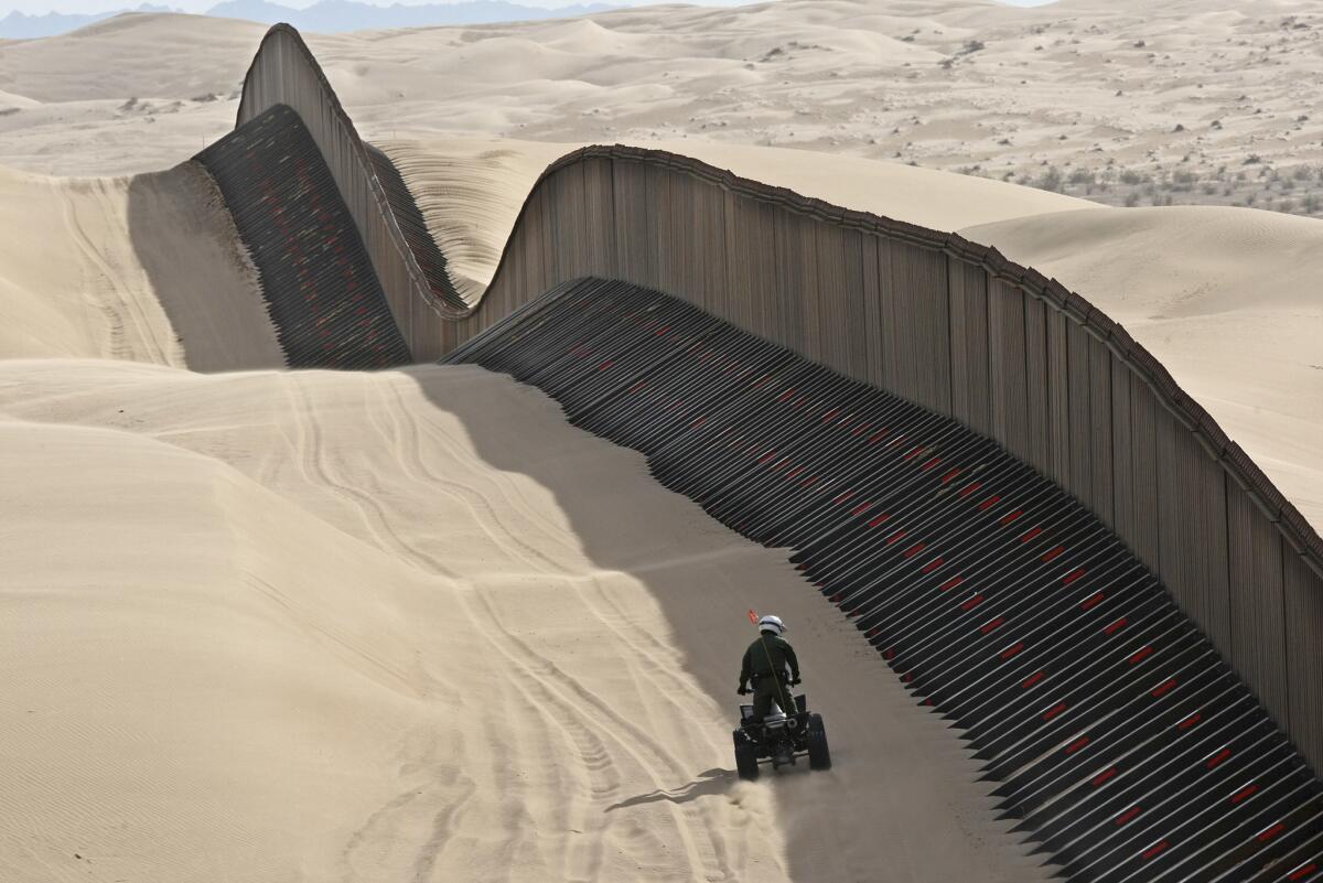 A Border Patrol agent along the "floating fence" that sits atop the Imperial Sand Dunes in southeastern California.