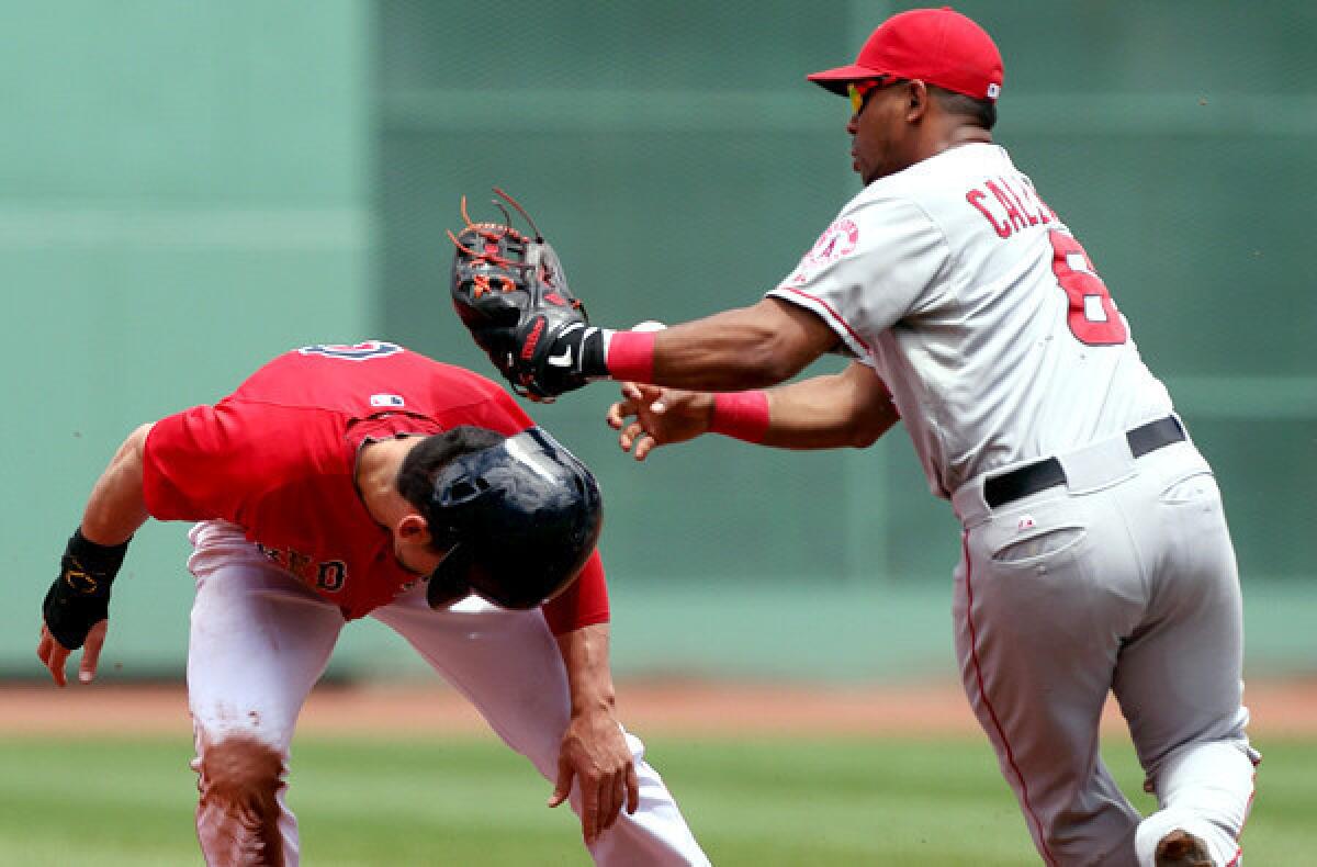 Angels third baseman Alberto Callaspo loses control of the ball as he tags Red Sox center fielder Jacoby Ellsbury between second and third bases during a rundown in the first inning of their doubleheader opener on Saturday at Fenway Park.