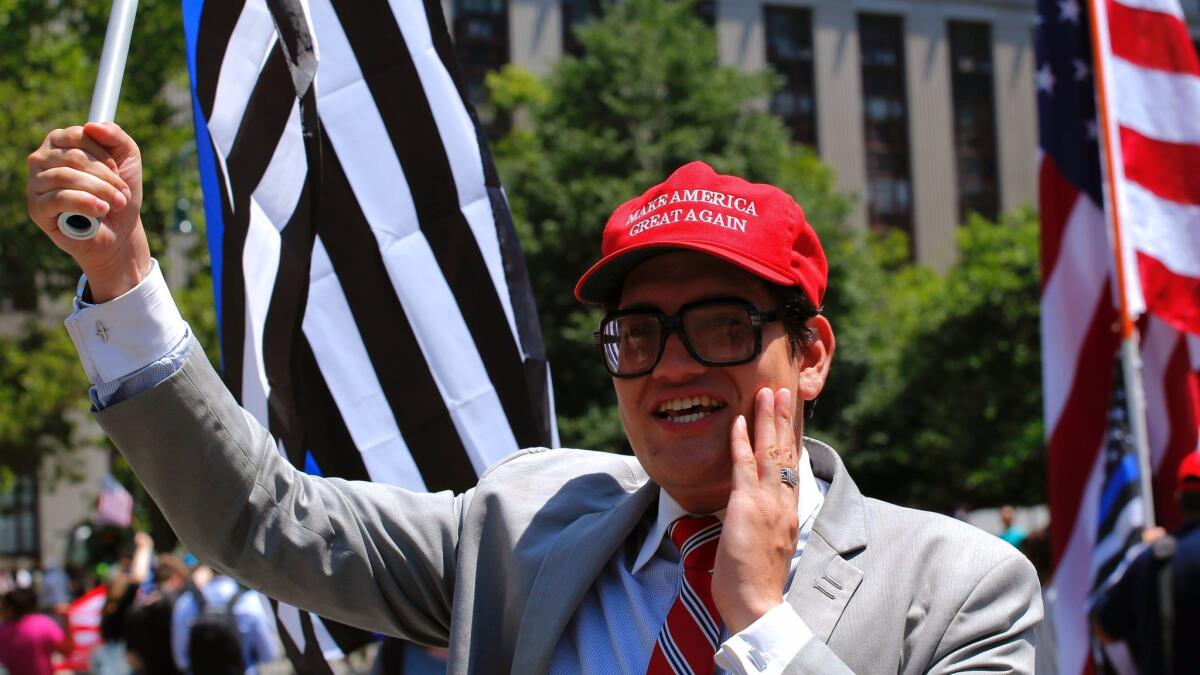 A supporter of President Trump waves a flag during an anti-Sharia law rally organized by Act for America on Saturday at Foley Square in New York.