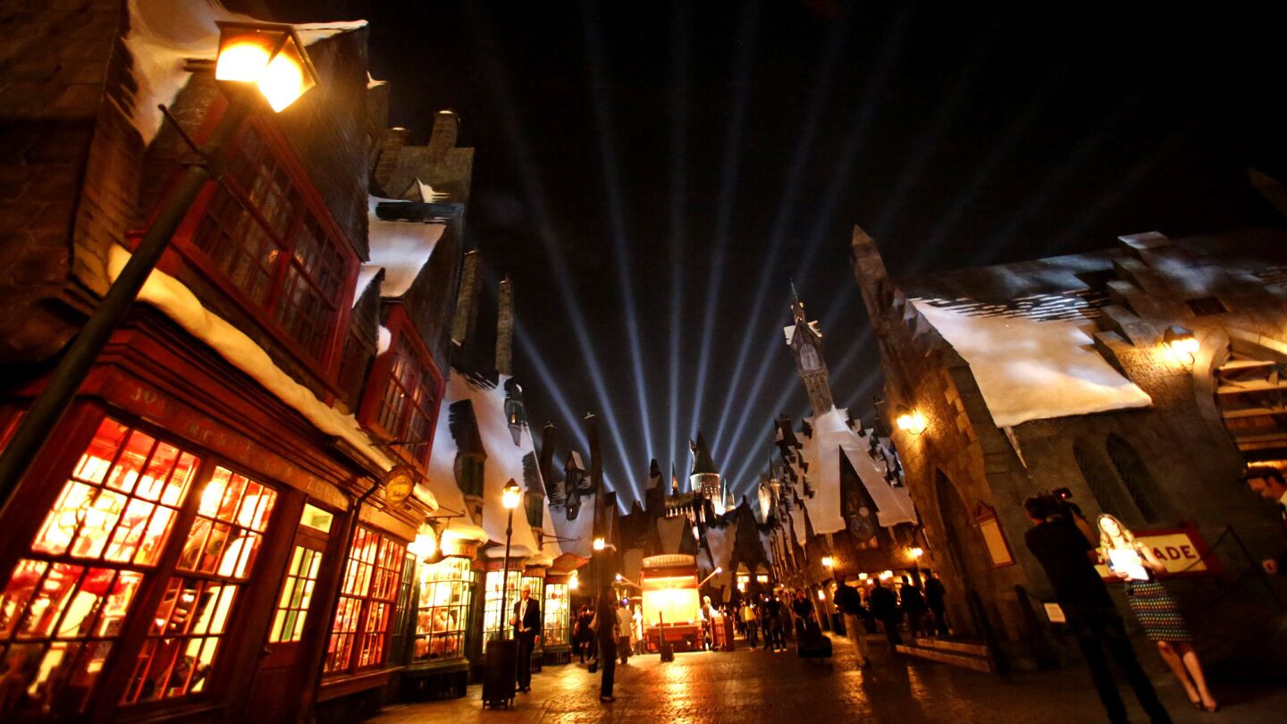 Visitors walk through the Wizarding World of Harry Potter during a media preview.