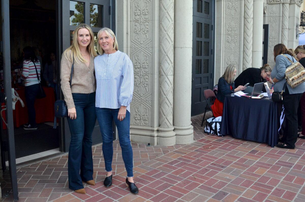 Natalie Gordon, left, and her mom, Lisa, enter Huntington Beach High School Auditorium.
