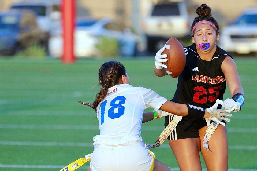 Orange Lutheran's Brookelynn Vanderkallen tries to rush past Santa Margarita's Mackenzie Young during a Trinity League game.