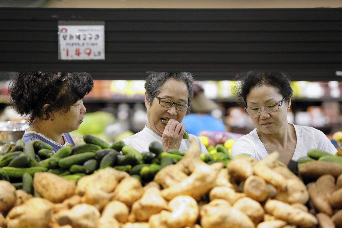 Jenny Kim, left, Cherry Shim and Young Casey shop at Super 1 Mart in La Palma. Orange County now has the third-largest Asian American population nationwide, and La Palma is the county's first Asian-majority city.