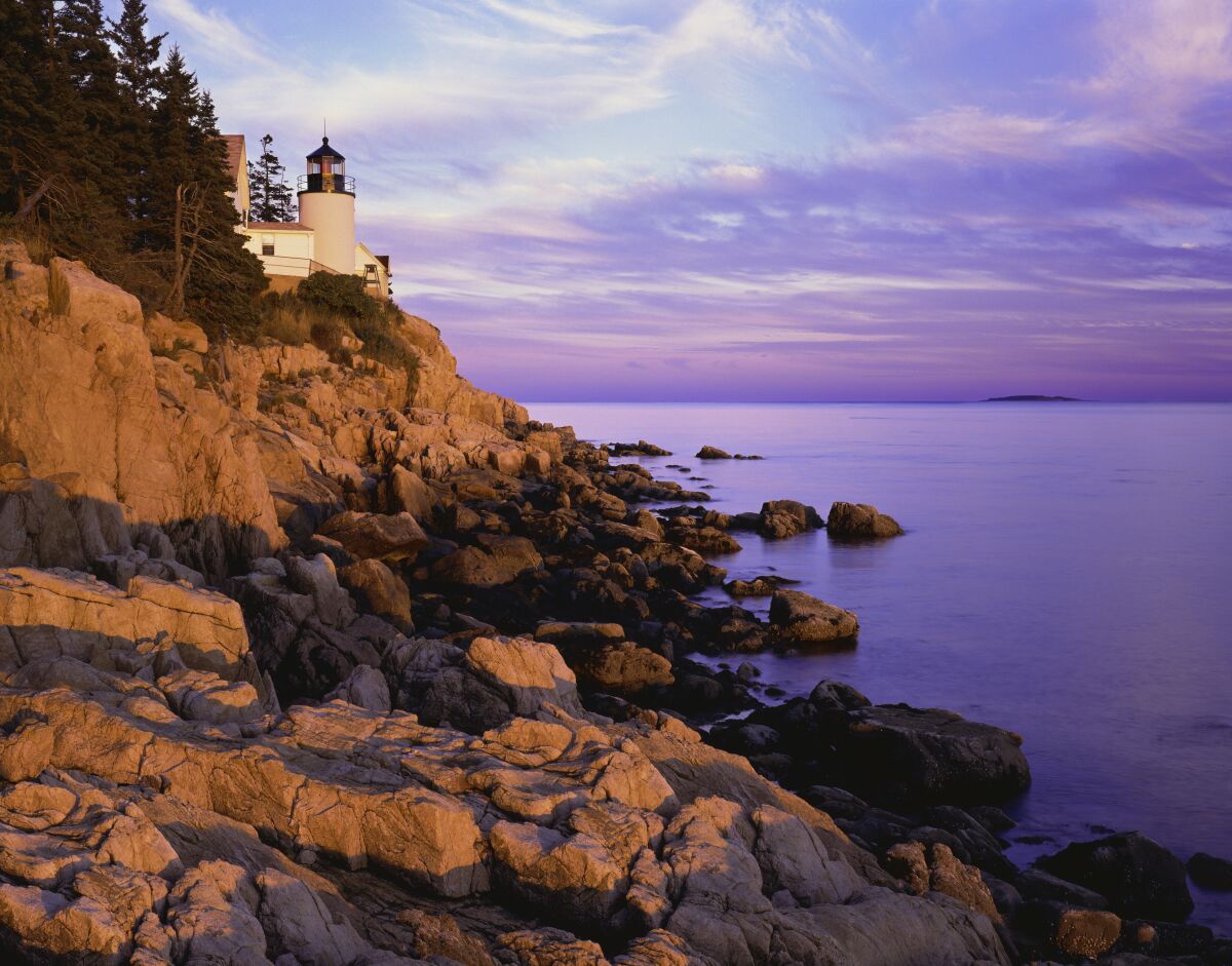 The Bass Harbor Lighthouse is seen on a rocky cliff in Acadia National Park in Maine.