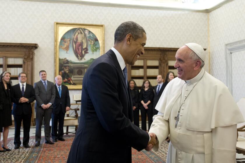Pope Francis and President Obama shake hands during a private audience on March 27 at the Vatican, where their talks focused in large part on improving U.S.-Cuban relations.