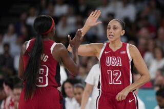 American Diana Taurasi celebrates with teammate Jackie Young during a women's quarterfinal win over Nigeria 