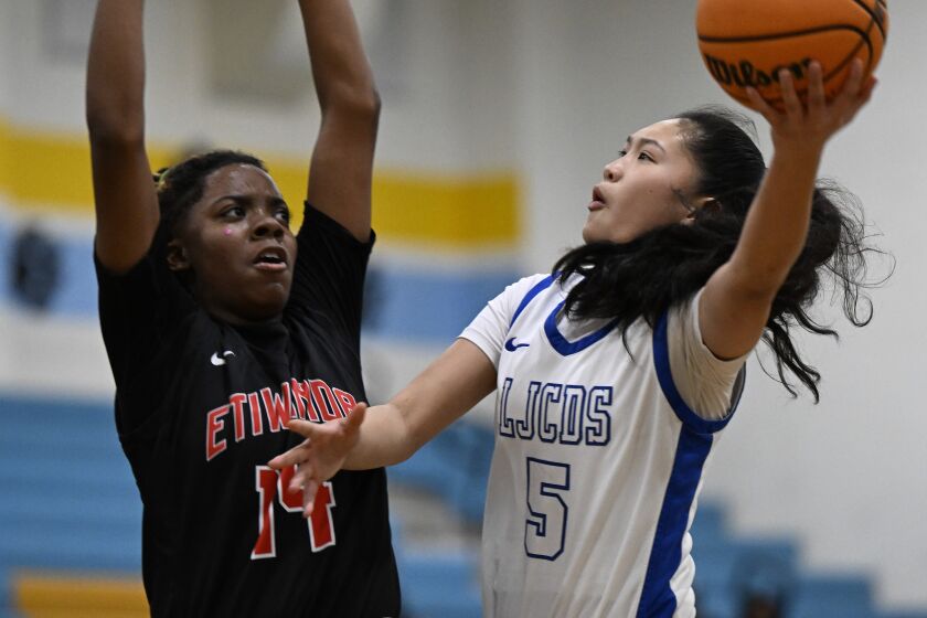 La Jolla Country Day's Sumayah Sugapong shoots over Etiwanda's Majesty Cade during the first quarter of a high school basketball at San Ysidro High School Jan. 28, 2023 in San Diego. (Photo by Denis Poroy)