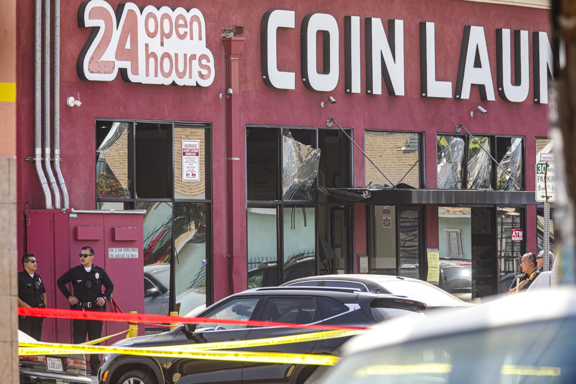 A coin laundry with broken windows.