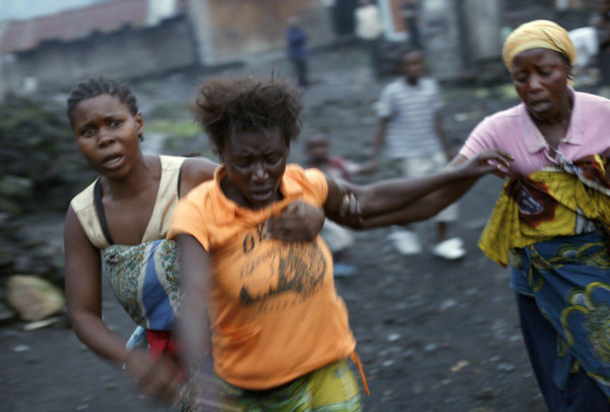 Congolese women flee fighting between Congolese soldiers and rebels around the eastern town of Sake, near Goma, on Thursday.