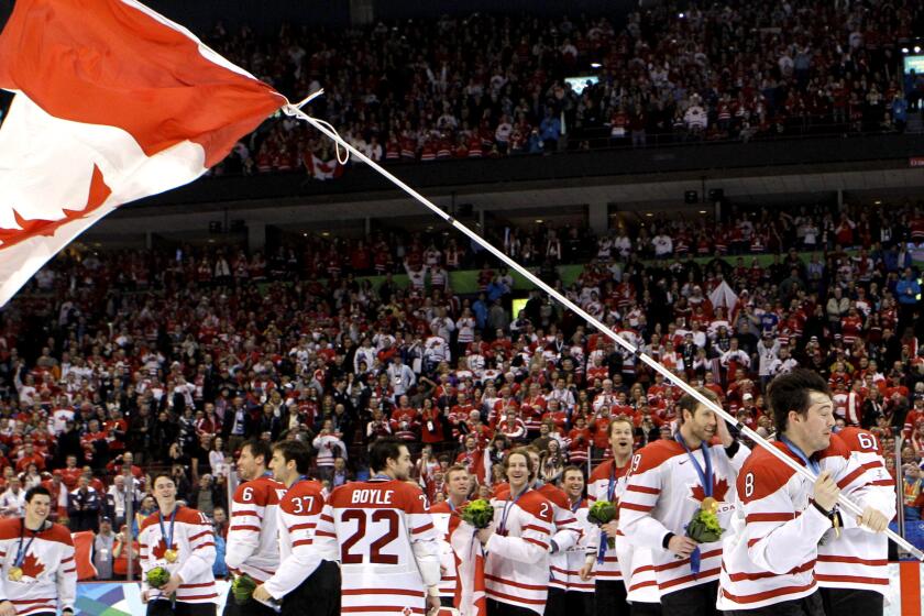 Canada's Drew Doughty (8) waves a Canadian flag after the men's ice hockey medal ceremony at the Vancouver 2010 Olympics in Vancouver, British Columbia, Sunday, Feb. 28, 2010. (AP Photo/Matt Slocum)