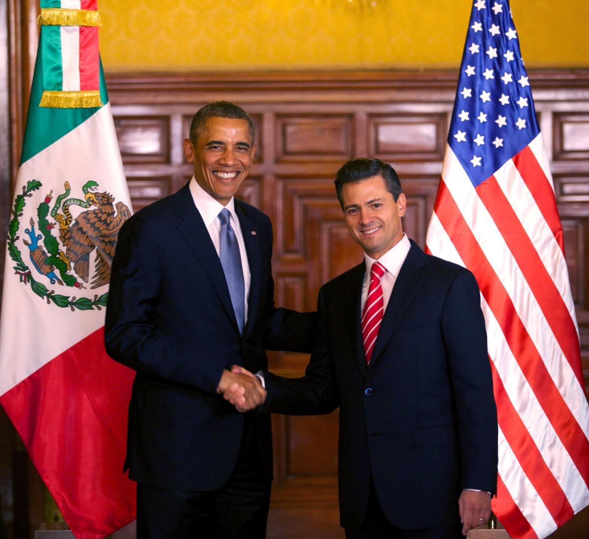 President Obama, left, is seen shaking hands with Mexican President Enrique Pena Nieto during a joint press conference at the National Palace in Mexico City.