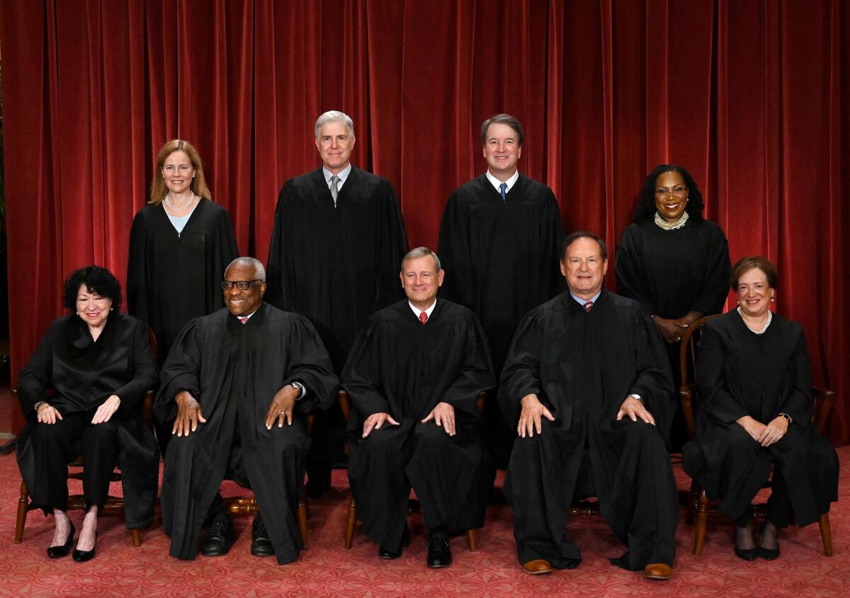Supreme Court justices in black robes pose for a group picture.