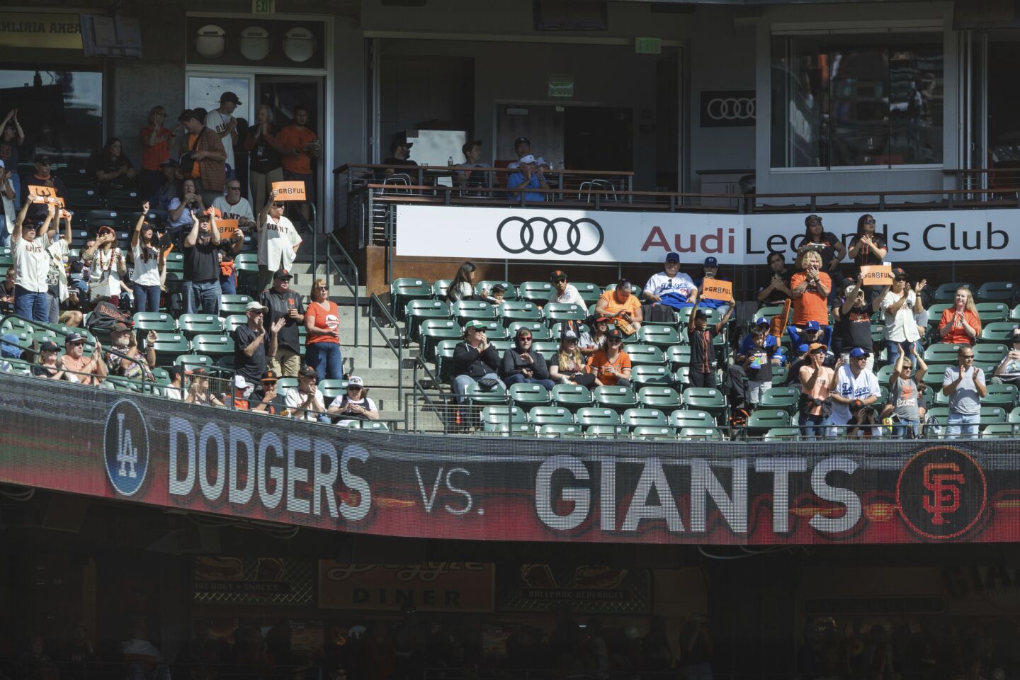 Fans watch the baseball game between the San Francisco Giants and the Los Angeles Dodgers in the first inning in San Francisco, Sunday, Sept. 30, 2018.