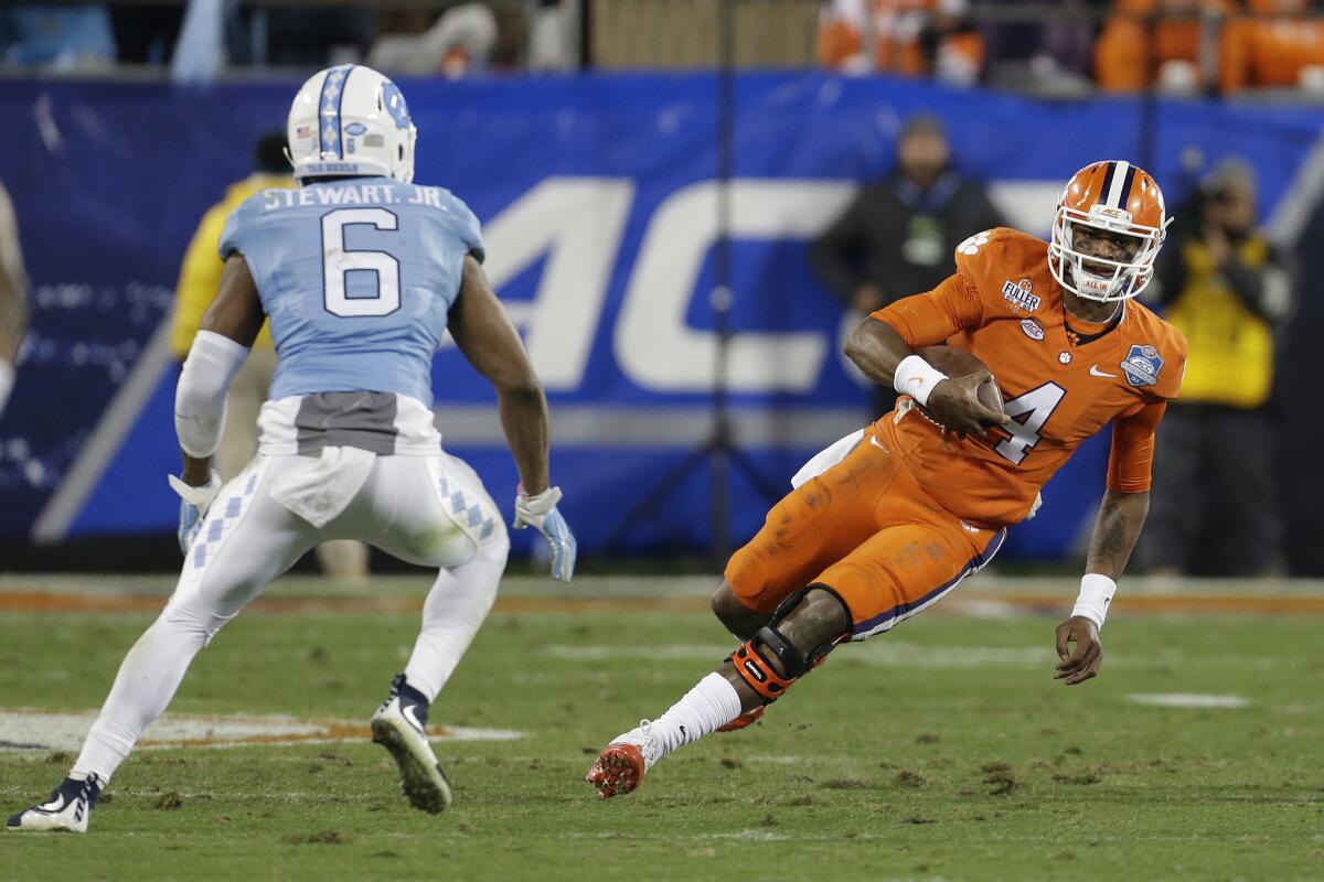 Clemson quarterback Deshaun Watson (4) tries to avoid North Carolina defender M.J. Stewart during the Atlantic Coast Conference 2015 football championship game in Charlotte, N.C. The ACC announced Wednesday that it will move all title events from North Carolina.