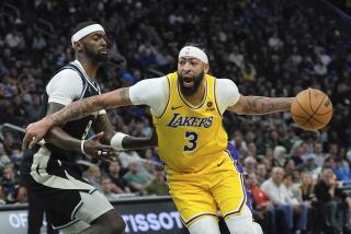Los Angeles Lakers' Anthony Davis gets past Milwaukee Bucks' Bobby Portis during the first half of an NBA basketball game Tuesday, March 26, 2024, in Milwaukee. (AP Photo/Morry Gash)