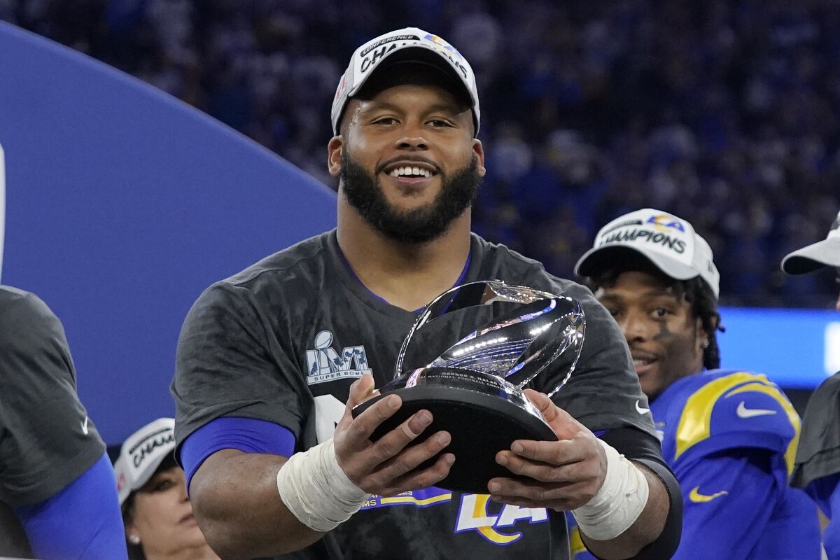 Los Angeles Rams' Aaron Donald holds the George Halas trophy after the NFC Championship NFL football game against the San Francisco 49ers Sunday, Jan. 30, 2022, in Inglewood, Calif. The Rams won 20-17 to advance to the Super Bowl. (AP Photo/Mark J. Terrill)