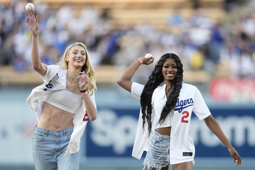 Cameron Brink and Rickea Jackson smile as they throw the ceremonial first pitches at Dodger Stadium