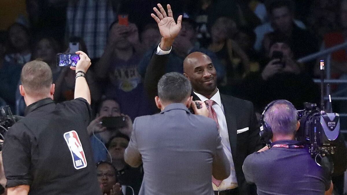 Lakers great Kobe Bryant, on hand for the unveiling of a tribute video, waves to the crowd at Staples Center during a game against Denver on Oct. 25.